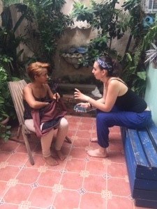 Annie and Arlette discussing their research project on gender and machismo on ANDA's patio.